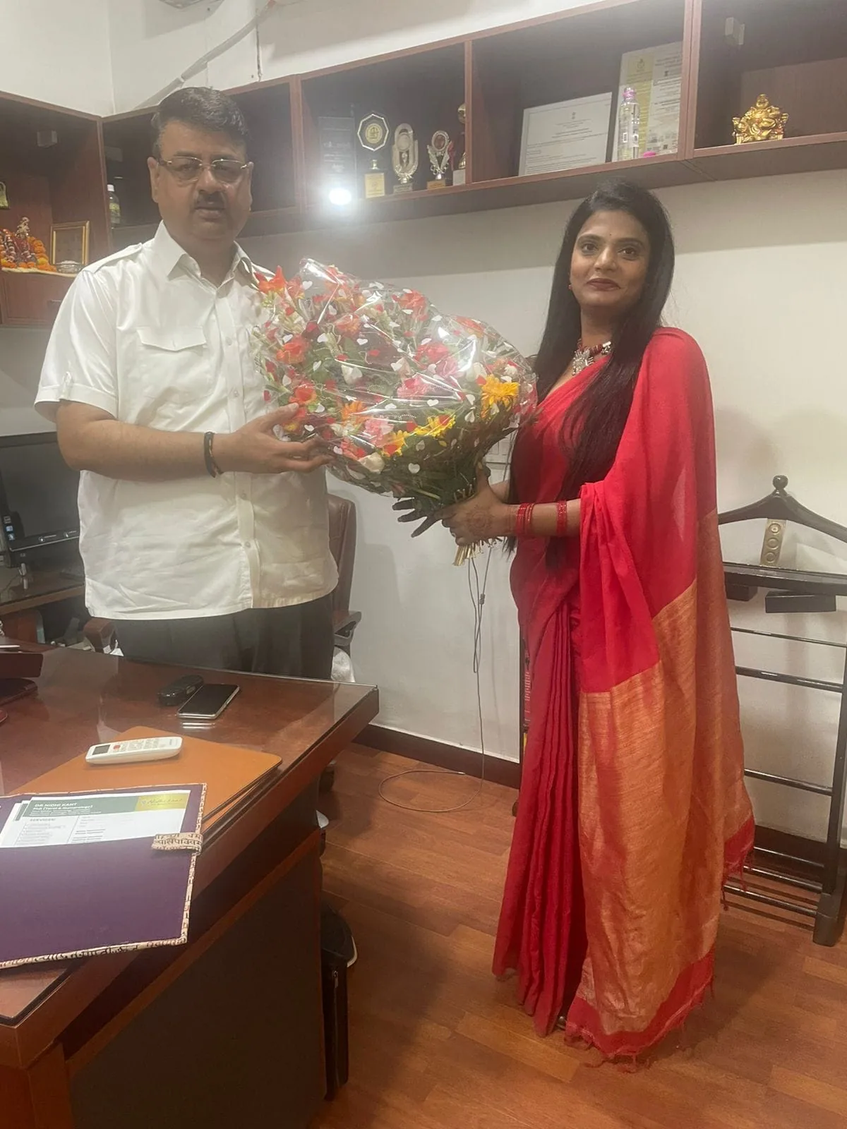 Dr. Nidhi Kant receiving flowers during a professional visit
