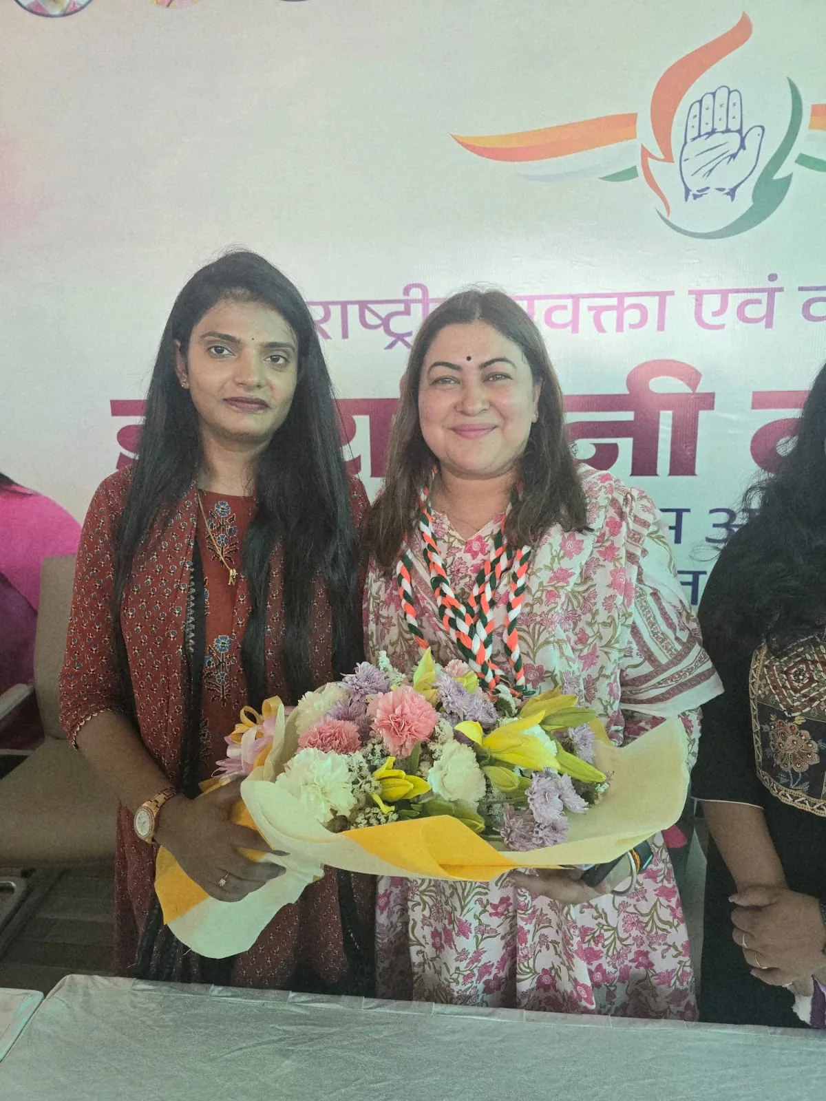 Dr. Nidhi Kant presenting a bouquet at a public gathering